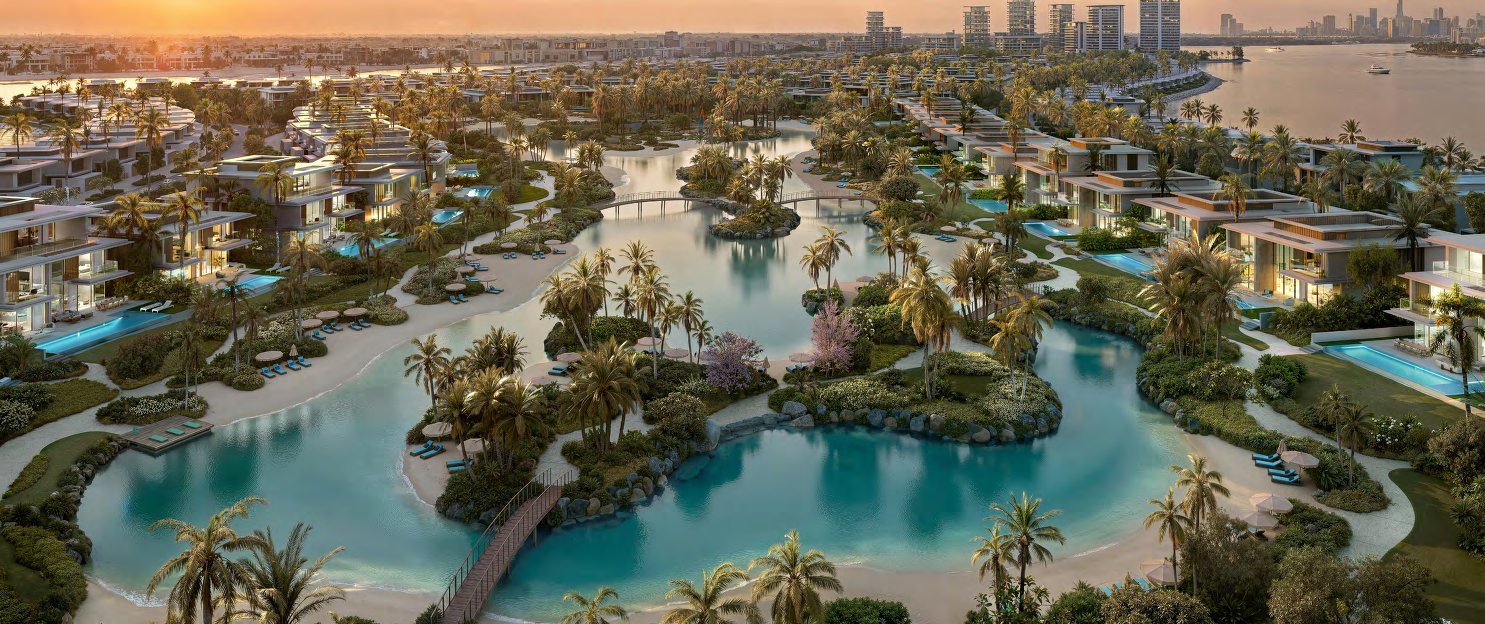 Villas with private pools around a palm-lined swimmable lagoon at sunset